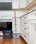RinseClean Spin Mop And Bucket system for clean water mopping in a kitchen, built-in foot pedal and dual-tank design visible