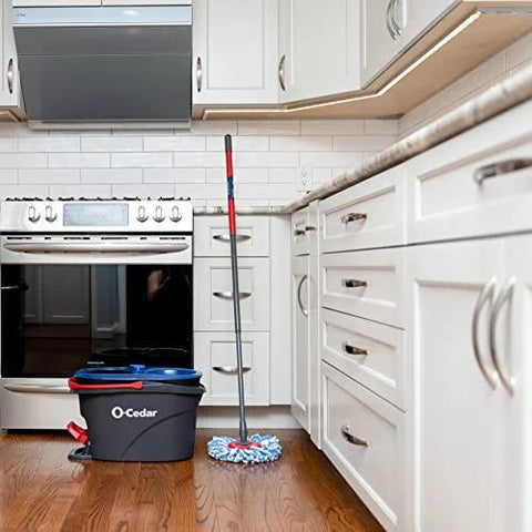 RinseClean Spin Mop And Bucket system for clean water mopping in a kitchen, built-in foot pedal and dual-tank design visible
