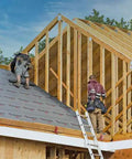 Two contractors installing Heavy Duty Synthetic Roof Underlayment Waterproof Felt Alternative on a pitched roof frame.