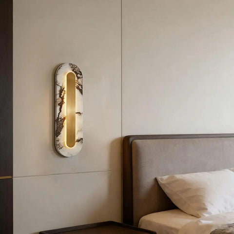 Modern Minimalist Long Marble Wall Sconce Nordic Alabaster Wall Mount Light Fixture illuminating a bedroom wall near a bed.