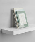 Crystal Clear L Shaped Bookends For Desk And Shelf Organization holding books on white shelf