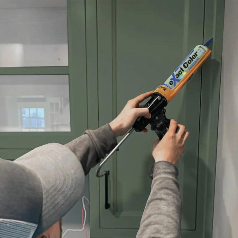 Applying Exact Color Custom Colored Caulk DIY Kit with 9.5 Ounce Cartridge for seamless edges on green cabinet.