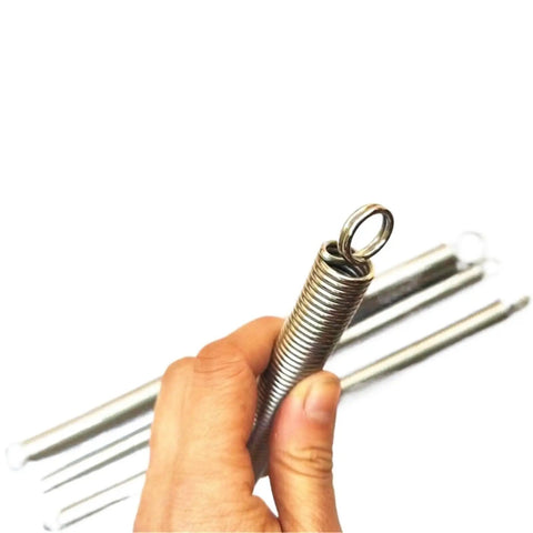 Heavy Duty Stainless Steel Extension Spring Featuring Beefy Gauge Wire For Garage Builds And Home Repairs, held in hand.