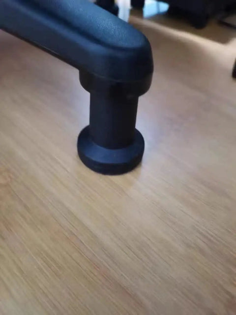 Close-up of a black bell glide from the 5 Pack Top Shelf Bell Glides For Office Chairs And Desk Stools on hardwood floor.