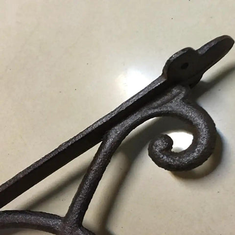 Hella Sturdy Rock Solid Cast Iron Wall Mounted Corner Support Brackets With A Killer Vintage Floral Design, angled view showcasing detailed metalwork.