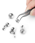 Premium Stainless Steel Precision Ball Bearing Set With 620 Pieces 12 Sizes shown with tweezers holding a bearing
