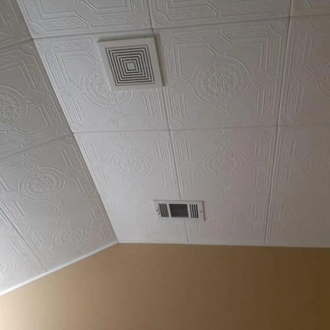 No Sweat Glue Up Foam Ceiling Tiles EZ Install Hides Popcorn Texture Fast Lightweight Styrofoam installed on a ceiling.