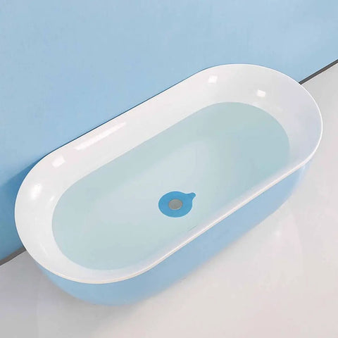 2pcs Silicone Tub Stopper Drain Plug Cover Strong Suction Seal in a modern blue bathtub with water.