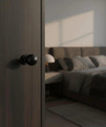 Close-up view of 10 Pack Matte Black Cabinet Knobs For Kitchen Cabinets Round Ball Pulls With Single Hole Design in a bedroom setting.