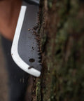 Gator Machete 25 Inch Two In One Machete With 18 Inch Plain Edge Blade And Reverse Saw cutting into tree bark, textured Gator Grip visible.