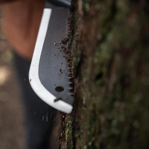 Gator Machete 25 Inch Two In One Machete With 18 Inch Plain Edge Blade And Reverse Saw cutting into tree bark, textured Gator Grip visible.