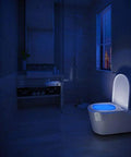 Bathroom with blue-glowing toilet using 3 Pack Rechargeable 16 Color Motion Sensor LED Toilet Night Lights With 5 Stage Dimmer IP67 Waterproof Light Detection No Batteries Needed Easy Install.