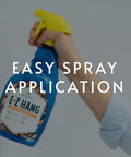 EZ Hang Peel And Stick Wallpaper Helper Clear Spray 32 oz bottle held in hand for easy spray application