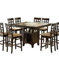 Hella Sturdy 9 Piece Square Dining Set With Counter Height Table featuring frosted glass top and tan upholstered chairs.