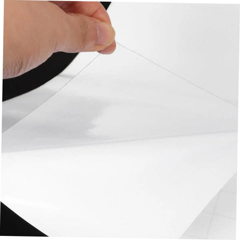 Clear Heavy Duty Self Adhesive Anti Scratch Tape For Sofa Couch And Door Frame Guard With Cat Dog Pet Window Edge Protector No Drama Peel And Stick being held.