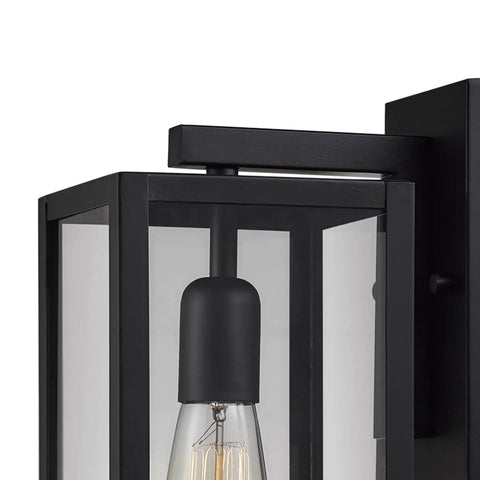 Close-up of One Light Outdoor Indoor Wall Sconce Dope Matte Black Finish With Clear Glass Shade Weather Resistant Modern Exterior Lighting