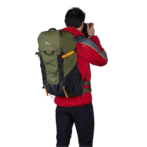 Person outdoors with PhotoSport X 35L AW Camera Backpack For DSLR And Mirrorless Gear With Rear Access And Mountain Ready Features