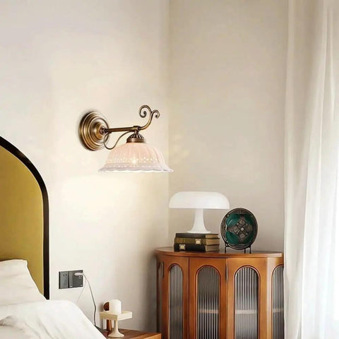 Ceramic Wall Sconce, 9 Inch Brass Vintage Light mounted beside a bed featuring an elegant patterned shade in a cozy bedroom.