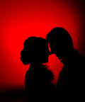 Silhouette of a couple against red lit backdrop using Red LED Light Bulbs 9W 60W Equivalent E26 A19 120V Four Pack For Bedroom Porch Holidays Parties