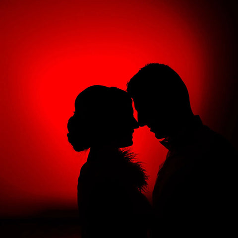 Silhouette of a couple against red lit backdrop using Red LED Light Bulbs 9W 60W Equivalent E26 A19 120V Four Pack For Bedroom Porch Holidays Parties