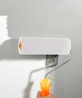 10 Pack White Sponge Paint Roller Covers Replacement Sleeves For House Painting Create Beautiful Texture Finishes With Soft Low Density Sponge Makes Walls Look Awesome Perfect For Large Areas And DIY Craft Nailing The Finish Every Single Time used with a paint roller on a gray wall.