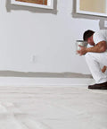 Painter using Heavy Duty 10 Ounce Canvas Drop Cloth 6 Feet By 9 Feet Tan 54 Sq Ft Contractor Grade Washable for indoor project