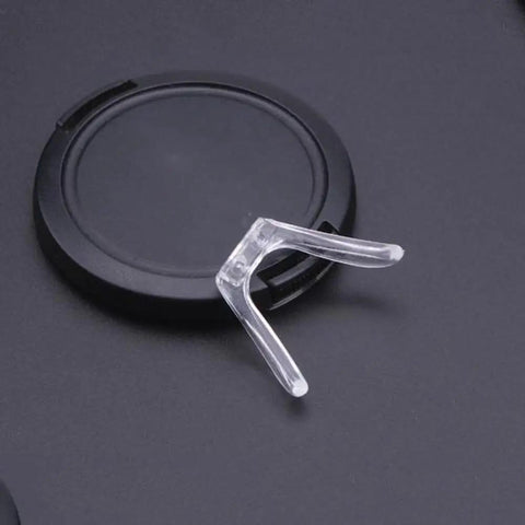 Pro Grade Rock Solid Gold Silicone Nose Pads For Glasses And Sunglasses Dead Stop Saddle Grip with a clear silicone nose pad on a black background.