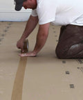 Person applying X Board Seam Tape Tan 1.89 Inch By 164 Foot Contractor Grade Adhesive for quick seam sealing on surface