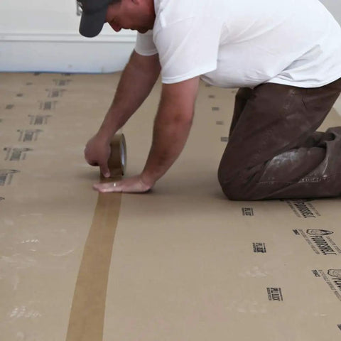 Person applying X Board Seam Tape Tan 1.89 Inch By 164 Foot Contractor Grade Adhesive for quick seam sealing on surface