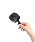 4pcs Swivel Caster Wheels Black for Furniture and Displays Inch held in hand, showing smooth design for easy installation.
