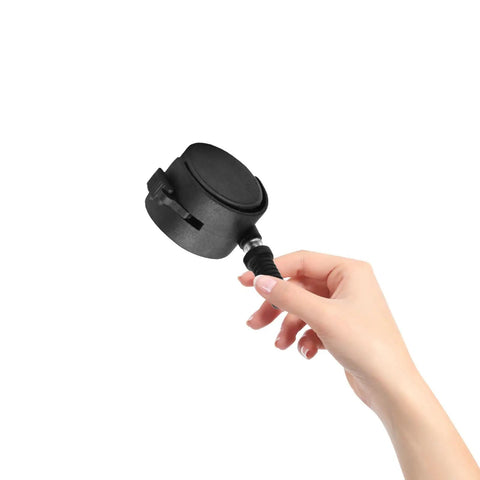 Hand holding a black 4pcs Inch Swivel Caster Wheel for Furniture and Displays, showcasing the sturdy design and brake feature.