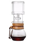 Kickback Ready Cold Brew Coffee Drip Tower With Adjustable Water Flow Slow Drip Tech portable brewer in transparent glass and wood.