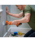 Person using 18V Cordless Oscillating Multi Tool Kit With Two 2.0Ah Batteries And Charger for precise wall cut