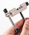 Stainless steel bike chain breaker remover tool for easy chain removal and installation, shown being held, black and silver finish.