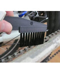 Cleaning bike chain with Bike Chain Cleaning Tool Set With Crankset Brush And Motorcycle Chain Cleaner Brushes, black handle visible.