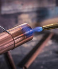 Trigger Start Butane Torch For Soldering And Welding in action, showing adjustable flame on copper pipe for precise metalwork.