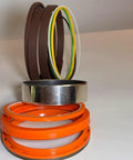 Killer Heavy Duty Hydraulic Seal Kit For Sumitomo SH130-5 Excavator Bucket Cylinder Repair Kit Including Piston Seals Rod Seals Dust Wiper Seals For Quick Fixes On Site Daily Maintenance And Repairs Ready Right Now, shown with orange and brown seals