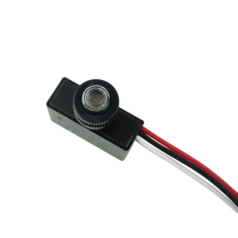 Close-up of the 2 Pack Outdoor Dusk To Dawn Photoelectric Switches For 120V AC Lighting showing sensor and wiring