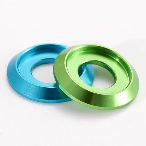 100-Piece Set of Badass M6 Titanium Gray Aluminum Grooved Washers Featuring a Sick Metallic Glow and Serious Durability with a Thin Gasket Profile Perfect for Tough Jobs in Your Garage in blue and green colors.