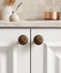 Heavy Duty 15 Piece Antique Brass Cabinet Knobs Offering A Hella Smooth Vintage Sunburst Finish on white cabinet drawers.