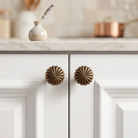 Heavy Duty 15 Piece Antique Brass Cabinet Knobs Offering A Hella Smooth Vintage Sunburst Finish on white cabinet drawers.