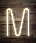 Led Neon Letters Sign Warm White Wall Decor Alphabet A To Z And 0 To 9 Marquee Letter Lights For Parties Weddings Valentines Day Home Bar Lounge And Creative Room Accent, letter M illuminated against wood background