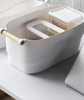 Top Shelf White Plastic Storage Basket With Lidless Opening For Zero Fuss Organization And Straight Up Space Saving Efficiency Ideal For Cozy Living Room Or Bedroom Vibes containing small storage container.