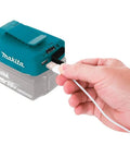 Hand plugging USB cable into 18V LXT Cordless Power Source With Dual USB Ports, 4.2A Total Output, Portable Charger