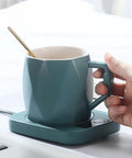 Rapid Heat Electric Cup Warmer Locks Your Favorite Brew Piping Hot Through The Entire Grind Temp Control Pad with a teal mug.