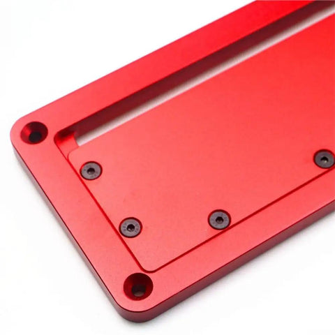 Close-up of a red Aluminum Alloy Flip Adjustable Throat Plate For Electric Circular Saw, Precision Table Saw Insert Plate.