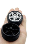 Close-up of Ten Pack 48mm Toy Car Rubber Wheels With 5 Shaft Axles for RC Cars Trucks Robots DIY Models on a hand