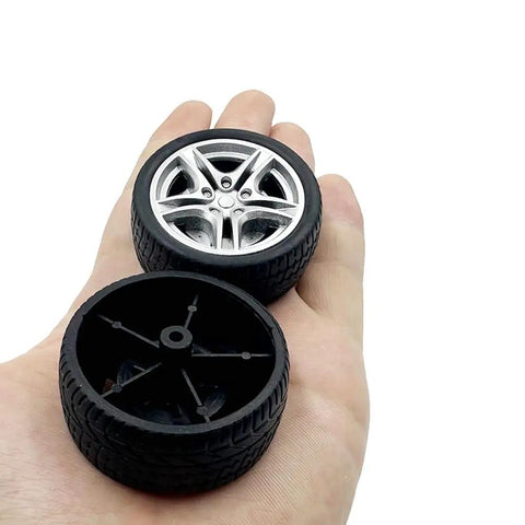 Close-up of Ten Pack 48mm Toy Car Rubber Wheels With 5 Shaft Axles for RC Cars Trucks Robots DIY Models on a hand