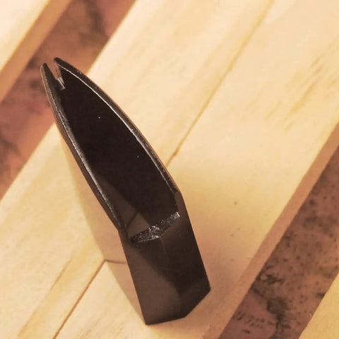Sturdy Brass Habaki Collar Clip for Katana and Japanese swords locks Tsuba in place, shown upright on wooden surface.
