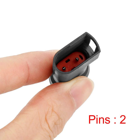 Rear brake pad wear sensor for Ford Transit; two-pin red connector, close-up held between fingers